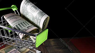 Dollars in the shopping trolley cart.