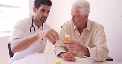 Male doctor giving prescription to senior man