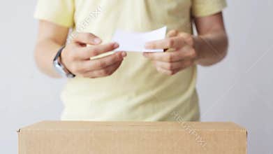 Man putting his vote into ballot box on election