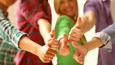 Students in school showing thumbs up