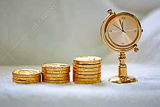 Rising pile of gold coins with a clock