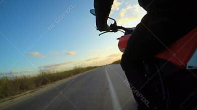 POV shot of from a fast motorcycle driving on a curved road