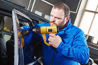 Car tinting. Automobile mechanic technician applying foil