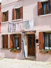 Hanging clothes, pink house, Burano, Venice