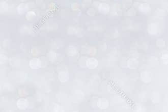 Bokeh soft pastel white background with blurred rainbow lights.