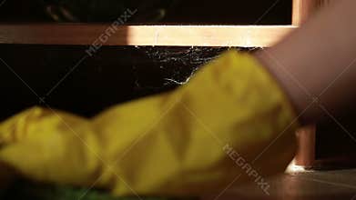 Woman cleaning the floor. girl in gloves cleans the kitchen