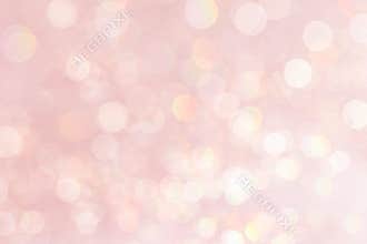 Bokeh soft pastel pink background with blurred golden lights.