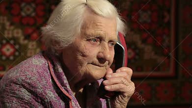 The Elderly Woman talking on the telephone With Rotary Dial Close Up