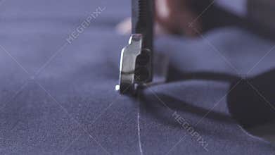 Cutting fabric. Blue cut out fabric for clothing in a textile factory.