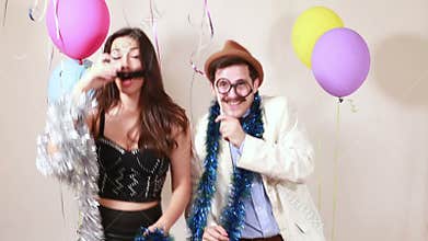 Woman and man having awesome time in photo booth