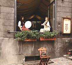 Girls in ancient Estonian clothes play on musical instruments