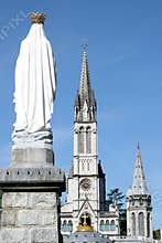 Virgin Mary and basilica in pilgrim town Lourdes