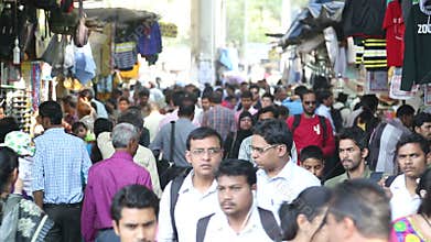 People walking through a crowded street of Mumbai.