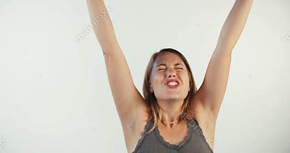 Young blond woman acting surprised and happy