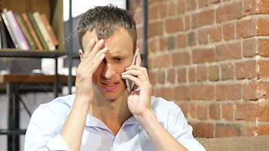 Angry businessman talking on the phone.Upset depressed businessman