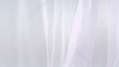 Sheer white curtains blowing in the wind