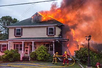 Firefighters battle blazing house fire