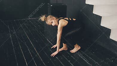 Modern beautiful teenage girl dancer perfomance contemporary dance in ballroom indoors