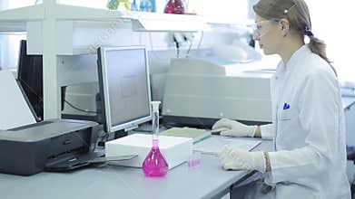 A woman in laboratory research. research in the research laboratory. woman scientist works in the laboratory. Attractive