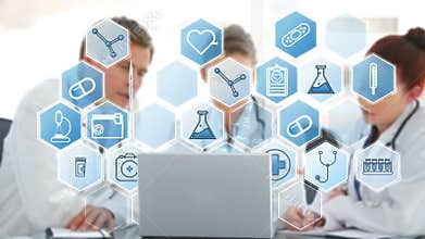 Doctors team discussing over laptop various icons