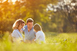 Parents with girl in green park