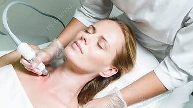 Serine lady enjoying skincare treatment at beauty salon