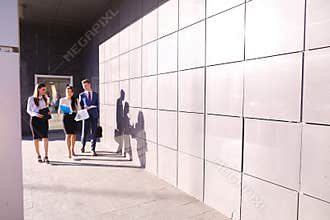 Three self-confident people, students, two girls and guy go and