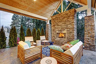 Chic covered back patio with built in gas fireplace