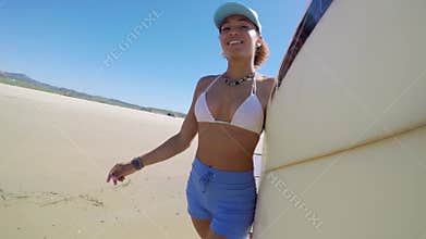 Woman with board holding a cap