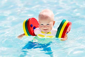 Little baby boy playing in swimming pool