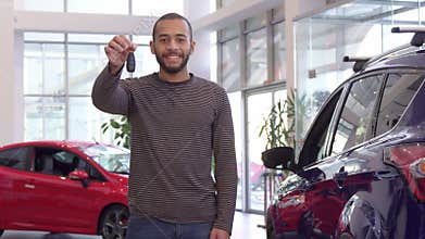 Guy holds car key in his hand