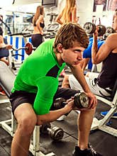 Fitness men friends in gym workout weights with equipment.