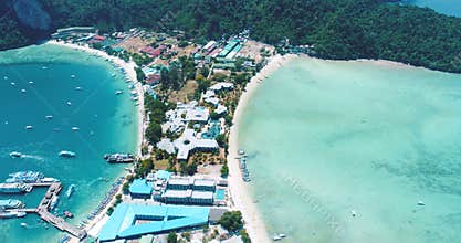 Aerial drone video of iconic tropical beach and resorts of Phi Phi island
