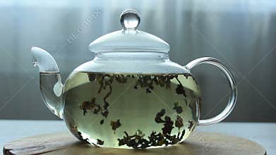 Video of Process of brewing green Chinese tea in a glass teapot