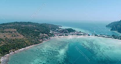 Aerial drone video of iconic tropical beach and resorts of Phi Phi island