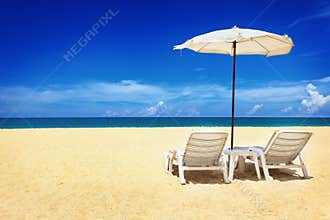 Two chairs and umbrella