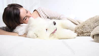 Smiling woman play with pet dog