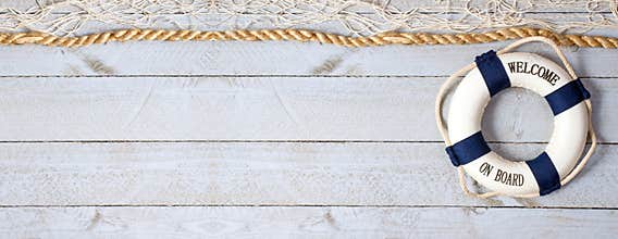 Welcome on Board - lifebuoy with text on wooden background