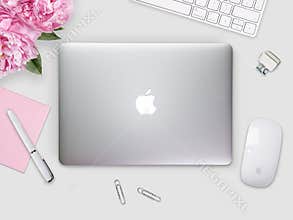 Apple Macbook Retina cover on a desk, table with mouse and stationery.
