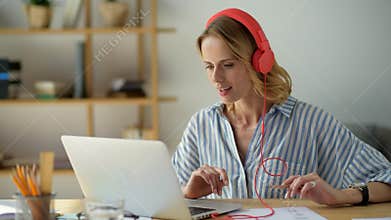 Beaming young lady studying online