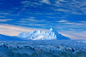 Land of ice. Travelling in Arctic Norway. White snowy mountain, blue glacier Svalbard, Norway. Ice in ocean. Iceberg in North pole