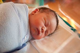 Swaddled new born baby