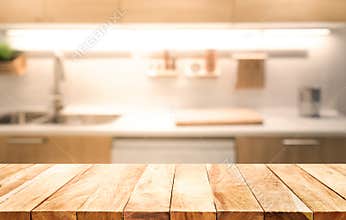 Wood table top on blur kitchen room background cooking concept