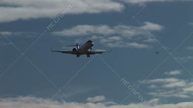Private jet landing low overhead