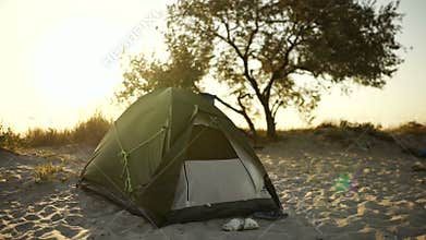 Tent camp during sunset or sunrise on the beach of the island