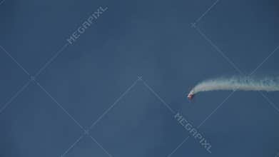 Biplane doing aerobatics in blue sky