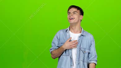 Guy jokes, he is not bored, he is happy and positive. Green screen