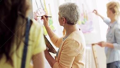 Group of students painting at art school studio