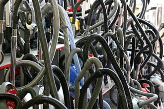 Vacuum cleaners with corrugated tubes
