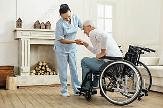 Nice senior man getting out from the wheelchair